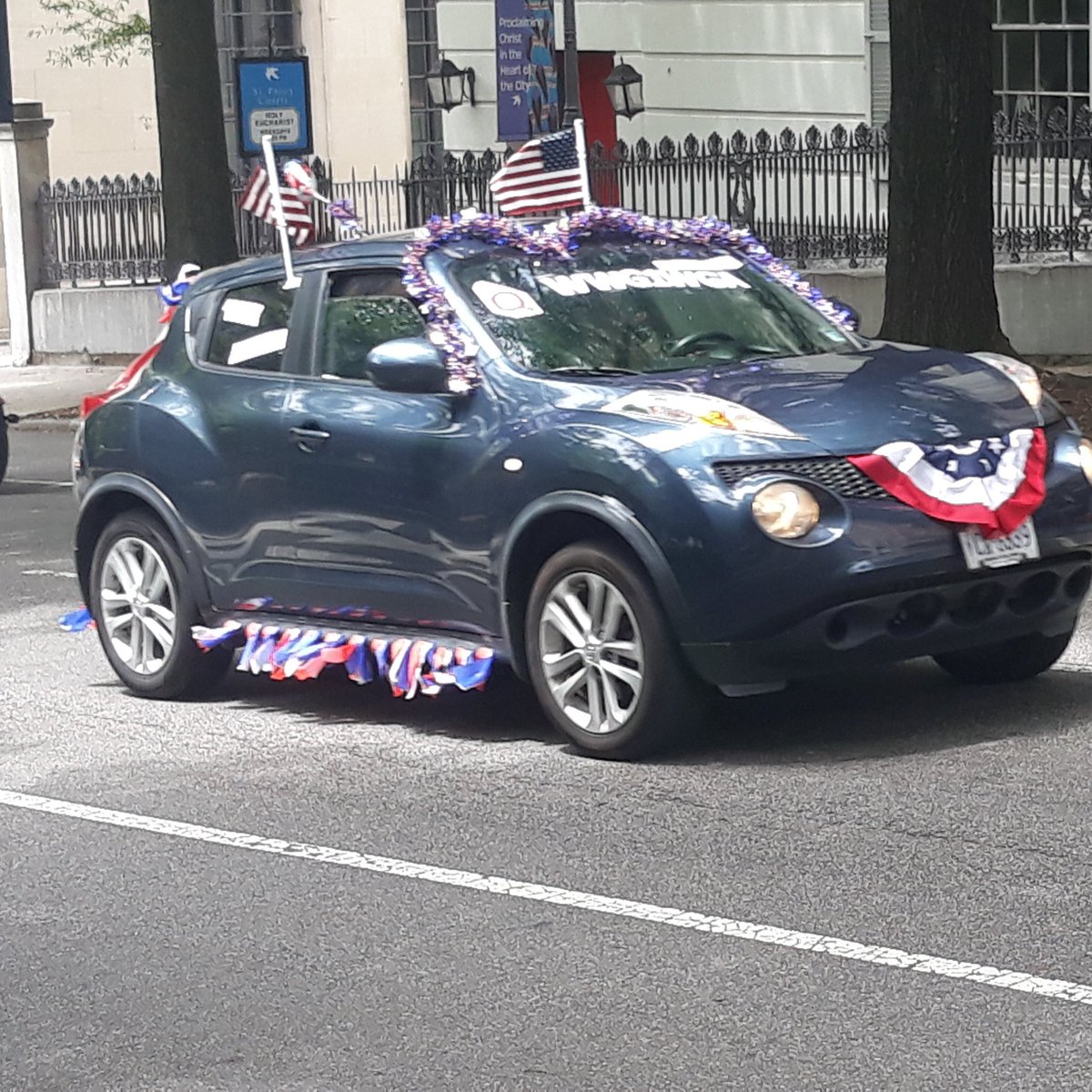 Here is a Q Anon themed SUV driving along with the rest of the motorcade