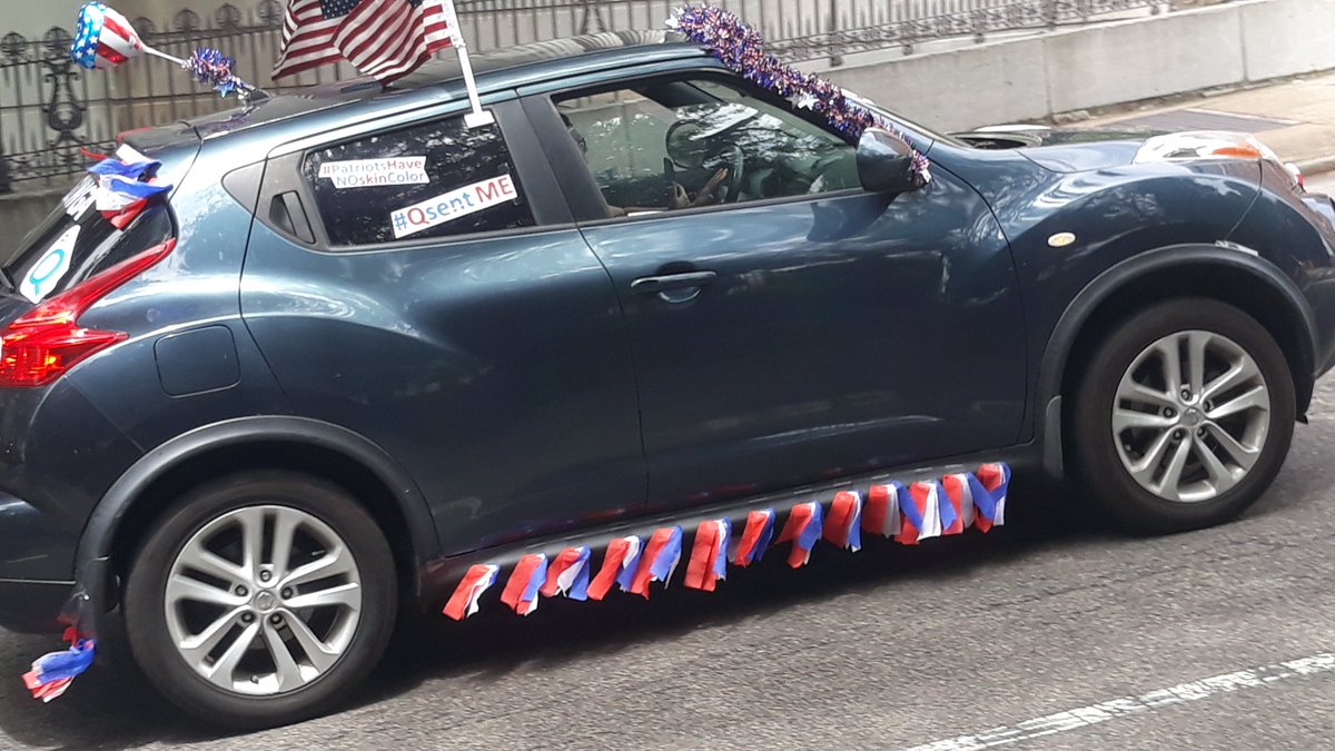 Here is a Q Anon themed SUV driving along with the rest of the motorcade