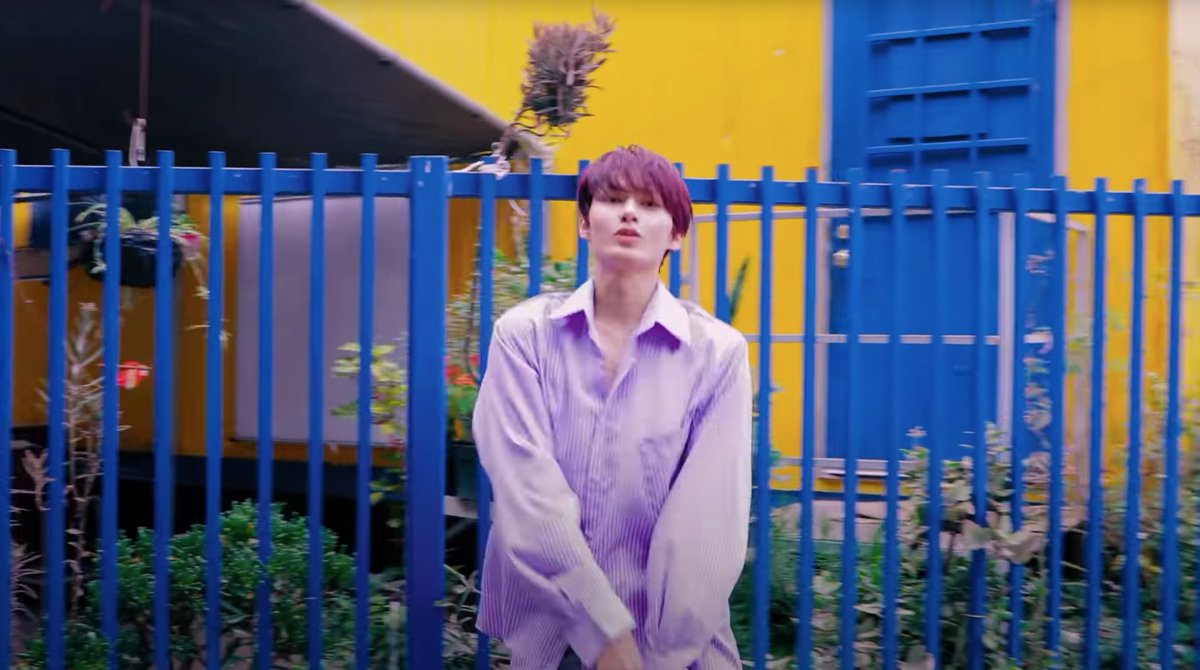  outfit as color accents jun's scene is purple-toned, but there are other colours. he's paired with purplish-grey & blue (toned, still the same tone tho) & has a yellow wall as an accent. though there are 3 main colours, it was well distributed & it creates its own harmony.