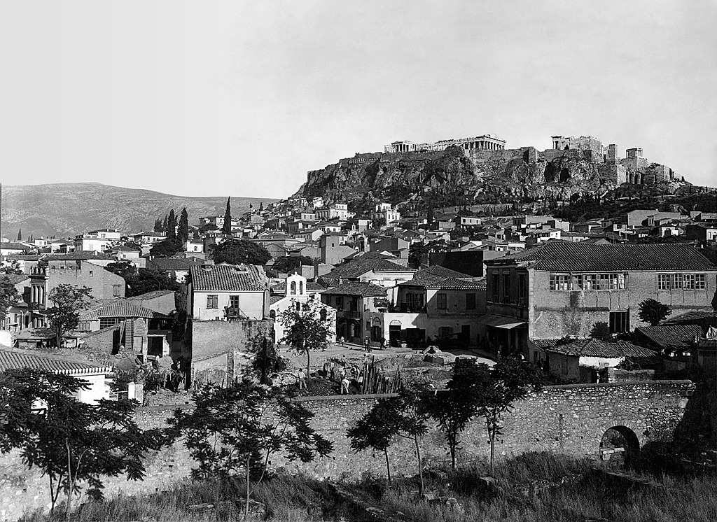 View looking across the area of the ancient Agora on the day excavations began May 25, 1931 by ASCSA in Athens. Section Ε and the Church of Vlassarou in the center with the Acropolis in the background.