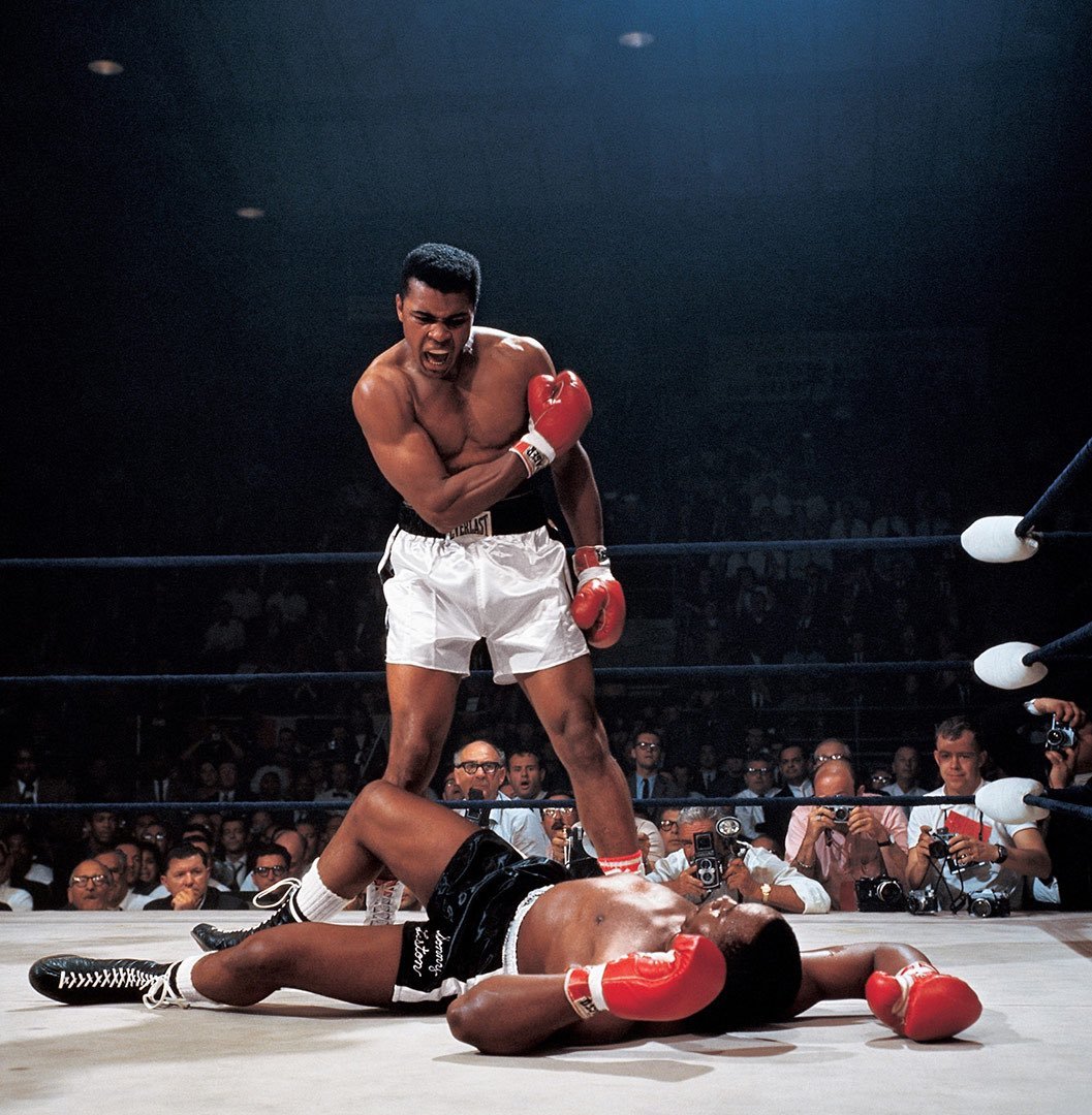 The photographer between Ali's legs is Herb Scharfman, an older rival of Leifer's at SI. He picked his spot by the scorer's table for better maneuvering, leaving Leifer on the other side. Worked out for Leifer!The stunned guy over Scharfman's shoulder? A young Larry Merchant.