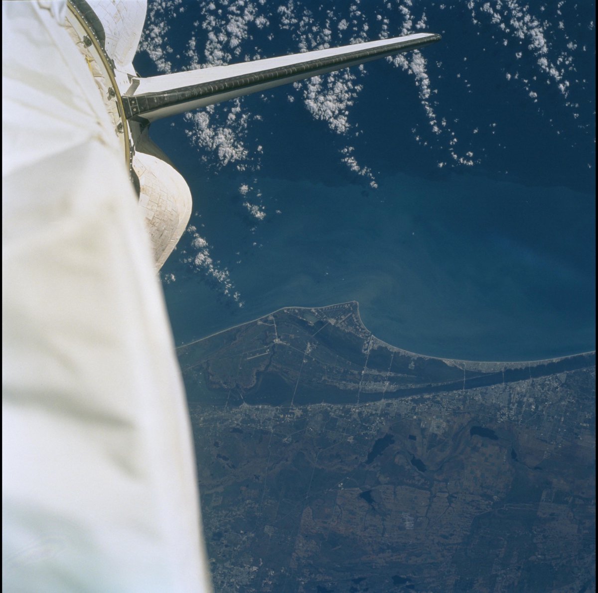 1 - STS-103 during a  @NASAHubble servicing mission, with the Space Coast below the solar array.2 - The tail end of Endeavour over the Space Coast during a Shuttle Radar Topography Mission on 2000-02-??