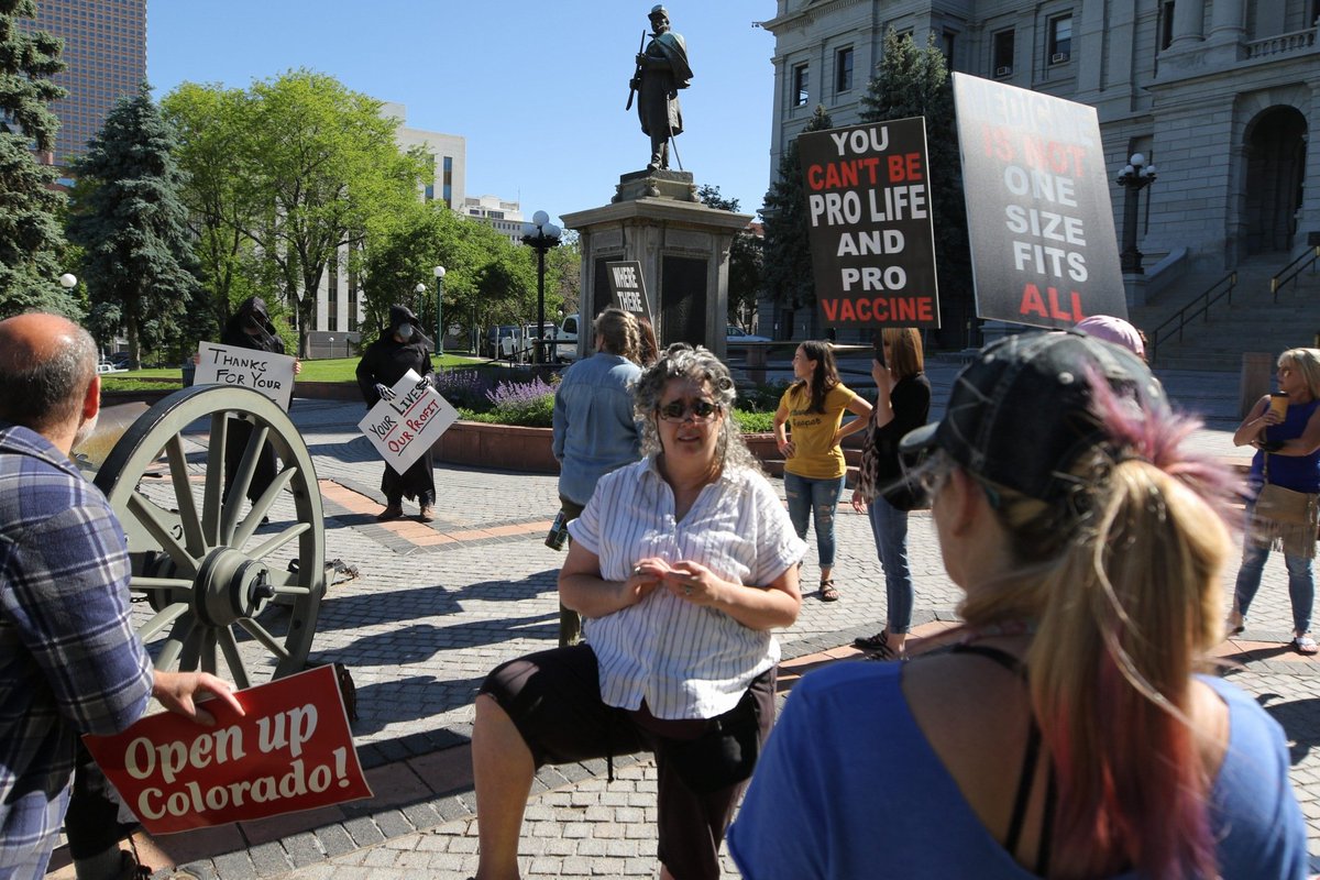 Meanwhile, an "open the state" protest is brewing up the hill. Folks here said the economy is dying and the COVID health crisis has been overblown. I see a sign that says, "vaccines are not placebo safety tested."