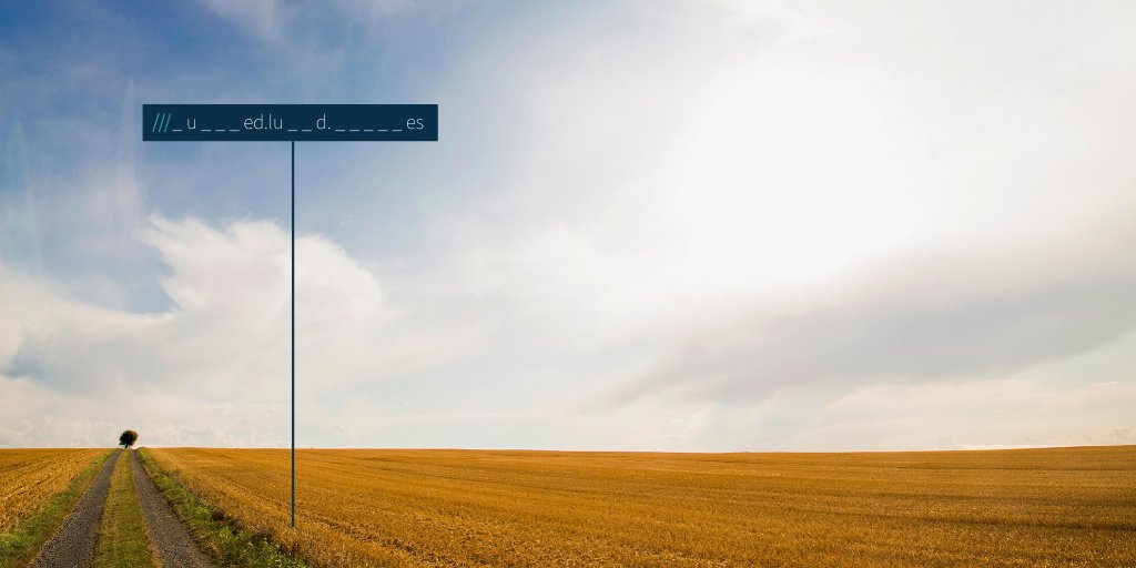 an empty cropped field with a lone tree on the horizon. An incomplete what3words address that reads ///_u___ed.lu__d._____es
