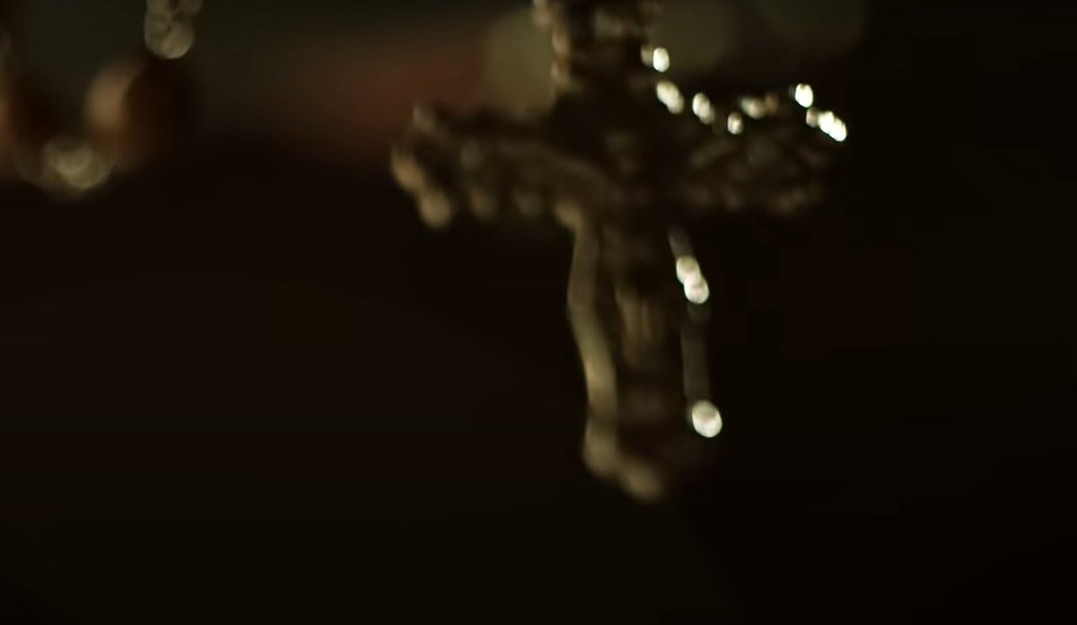 This shot is Immediately followed by dangling crucifix