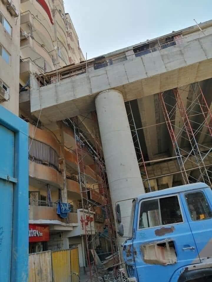 KarlreMarks's tweet photo. This is incredible, they built this bridge right by those buildings in Egypt. You can reach out and touch it from the balconies. https://t.co/lzfoZ5beAa