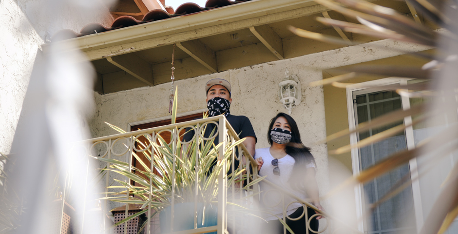 couple at home wearing cloth face coverings
