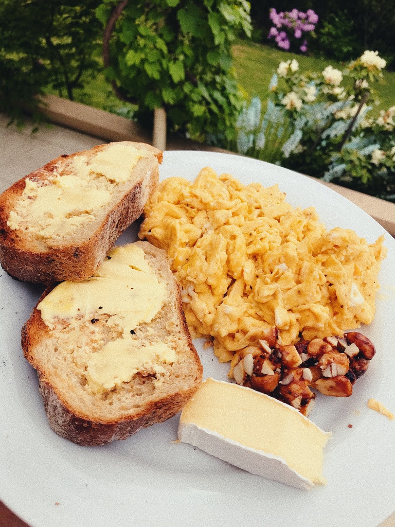Sourdough Toast used as a crunchy complement to a soft meal of scrambled eggs, brie and honey roasted macadamias