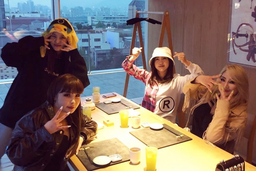 soompi's tweet photo. WATCH: #2NE1 Members Reunite For 11th Anniversary Via Video Call #11YearsWith2NE1 https://t.co/rBvkjhIxr6 https://t.co/JGUh19yo9e