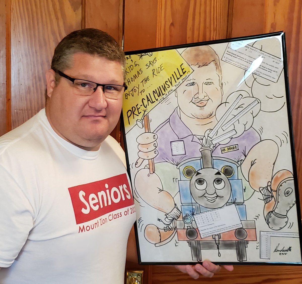 matthew_t_moore's tweet photo. 2020 Graduation today. 
Great gift from staff as I leave for a new teaching adventure. Thanks!
but,
I went to my basement where a caricature of me hangs from an art teaching legend that he surprised me with when he retired. 
We teach on the shoulders of legends
#prizedpossesion https://t.co/grXKQ1zlXO