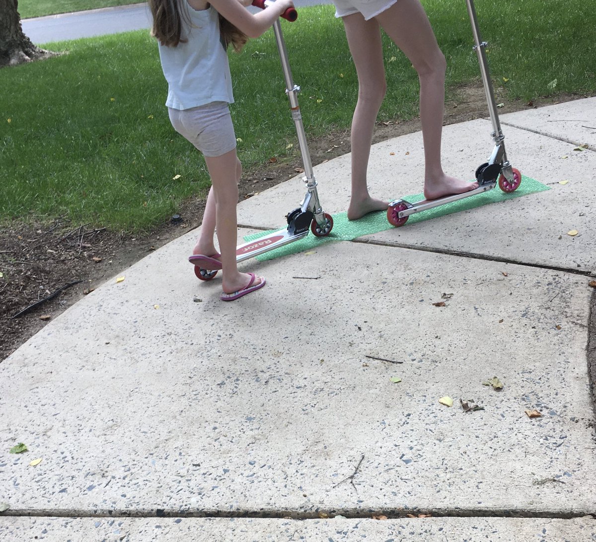 DrAmandaMcGough's tweet photo. My kids are having a blast rolling over sheets of bubble wrap with their scooters! #MovingFun #bubblewraprocks https://t.co/pQnG4zlFe9