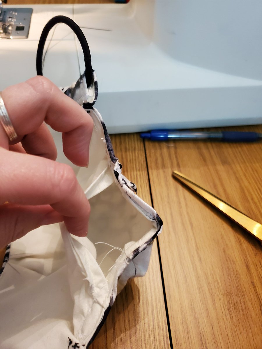 schmemela's tweet photo. Tested my #SewingSkillz with #EmilysMask today! First time sewing box pleats (woo!), and I don't have interfacing so modified it to add a filter pocket! #QuarantineCrafts #PrettyProud https://t.co/ickQQDPIMV