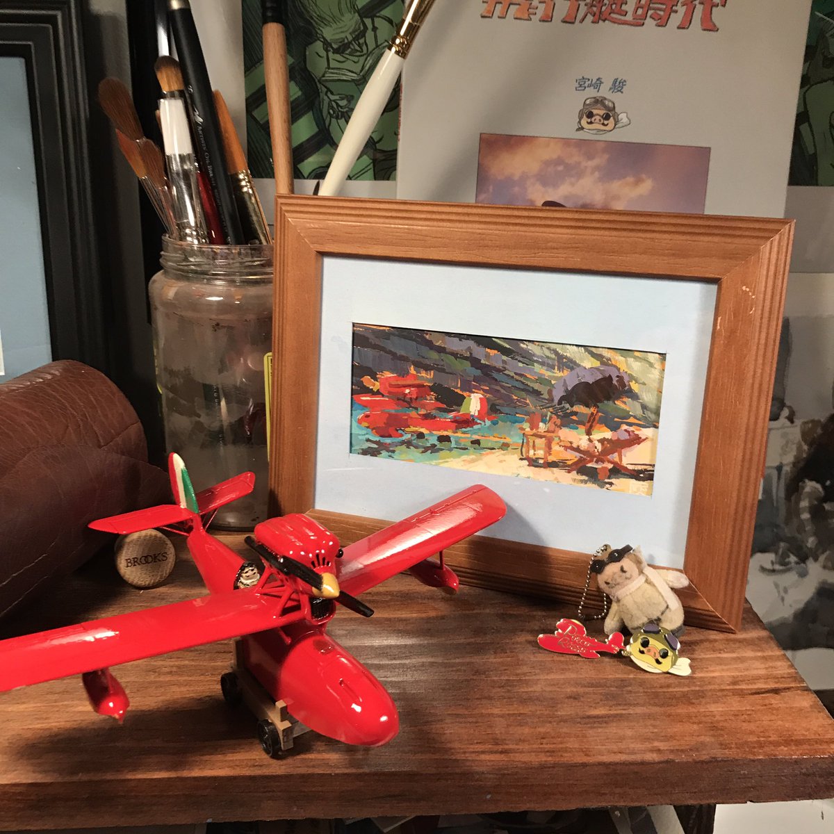 Jared_Cullum's tweet photo. THANK YOU @dasdrew_ for this original Porco Rosso gouache painting. It sits above my desk. I love it. I can’t decide if I’m more jealous of your skill I’d your signature stamp in the back :) so cool. https://t.co/mwfpfyfhDV