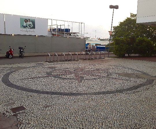A compass outside one of the city's shopping centres. The calceteiros' attention to detail made sure that it's offset to the line of the street, and pointing in the right direction!