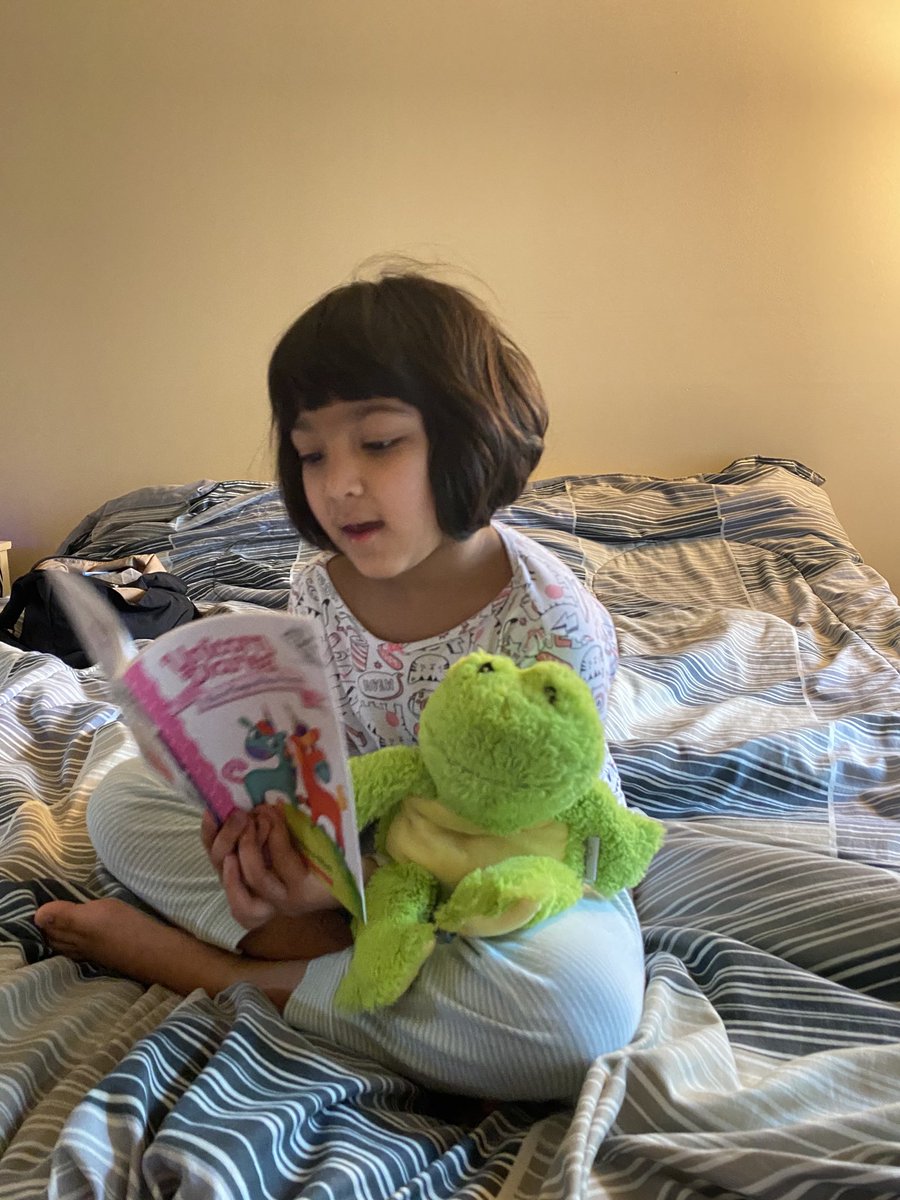 pat_sneha's tweet photo. Arya reading her Unicorn Diaries Book to her stuffed frog! ⁦@d61stachnik⁩,#d61learns https://t.co/ogZiuhjg01