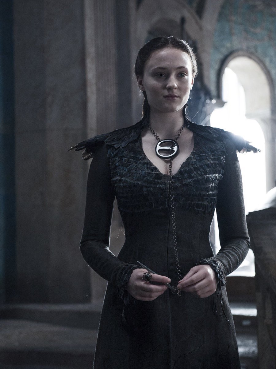 Attached to the bodice there is a chain with a needle at the end of it. Sansa had been wearing that style of jewelry since season 4