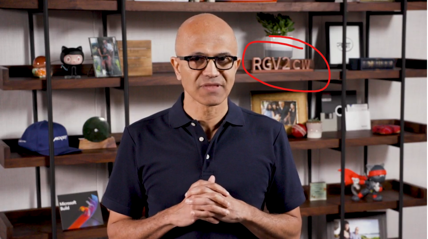 bhargavs's tweet photo. What is that RGV2cw behind Satya on the bookshelf? #microsoftbuild2020 https://t.co/8mesev1Nmm