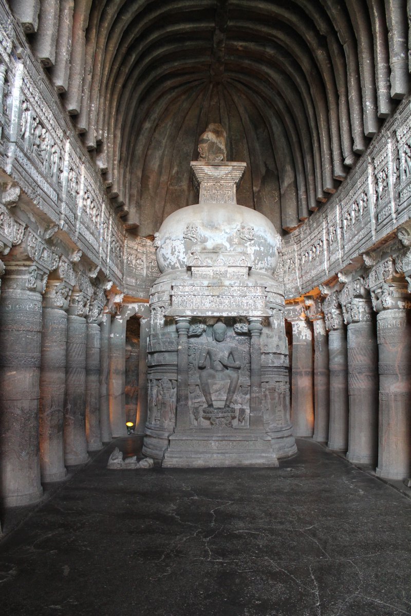 A large relief sculpture of the Buddha, standing in Cave 19 and seated in Cave 26.