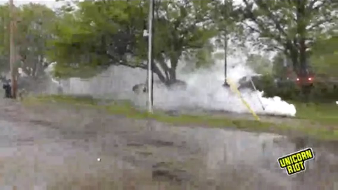 Minneapolis Police in riot gear continuing to fire lots of tear gas. The explosive canisters started a few small fires which we saw put out by protesters