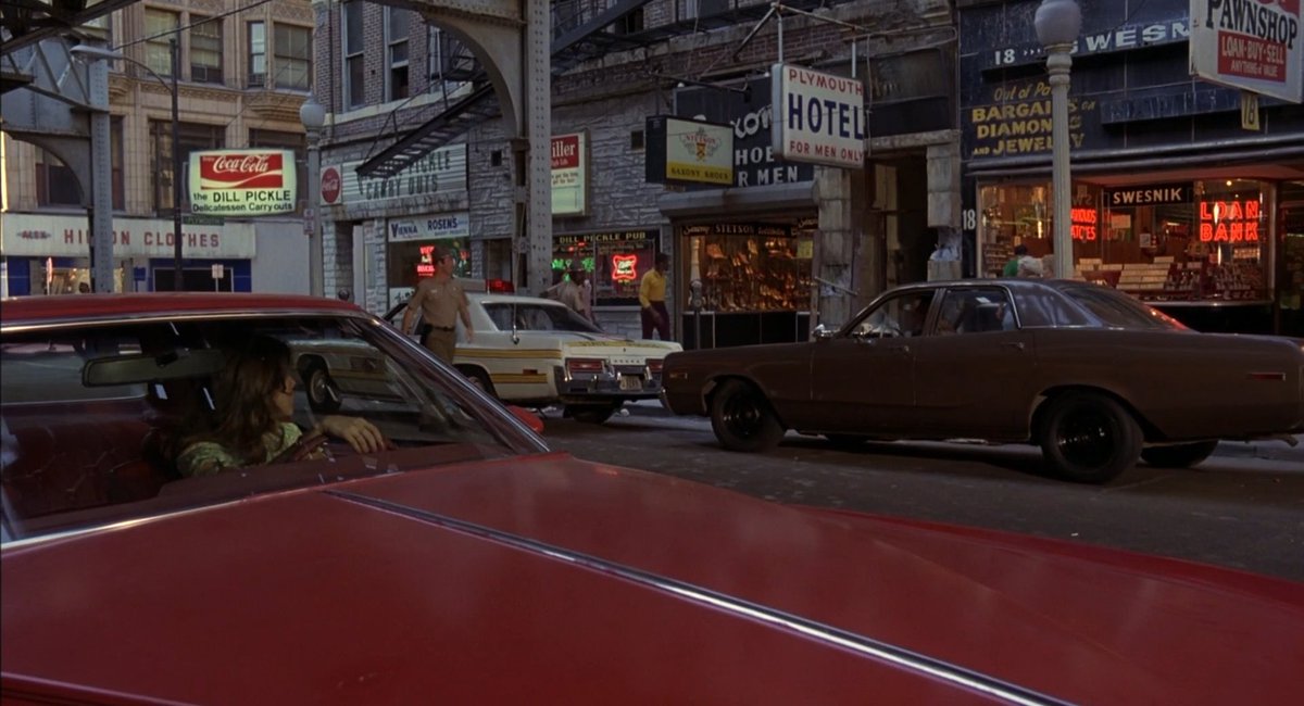 There's scant information about how this shot was accomplished - from what I heard, Whitlock printed a photographic frame of the street onto a relatively simple foam miniature.A real frame of film from earlier in the sequence, and the first shot of the vfx shot.