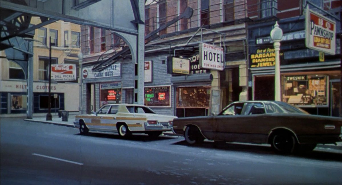 There's scant information about how this shot was accomplished - from what I heard, Whitlock printed a photographic frame of the street onto a relatively simple foam miniature.A real frame of film from earlier in the sequence, and the first shot of the vfx shot.