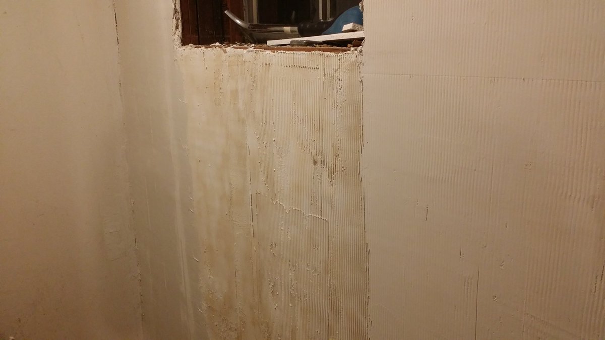 End of the day and the wall has transformed somewhat.No this is not the "normal" method but it is how I was taught by a professional plasterer--not a taper, big difference.The discolouration is caused by the now rough paper covering bleeding through the commpound.