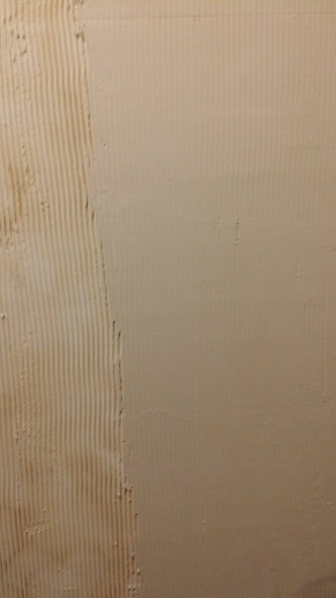 End of the day and the wall has transformed somewhat.No this is not the "normal" method but it is how I was taught by a professional plasterer--not a taper, big difference.The discolouration is caused by the now rough paper covering bleeding through the commpound.