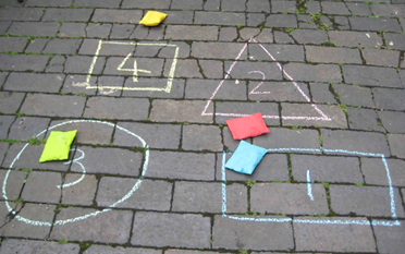 crofton_maths's tweet photo. The sun is shining so why not take Maths outside☀️See if you can create something like this! Throw the beanbags/ soft objects and see who scores the highest total. Or you might want to see who can throw all of the objects into a certain shape. @croftoninf_PE incorporating PE too! https://t.co/aeAfI9ub9Z