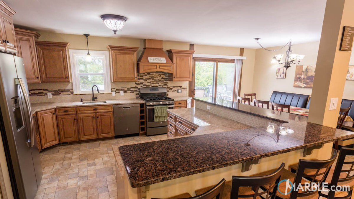 Marbledotcom's tweet photo. Terra Brown granite is a popular option for traditional country-style kitchens. How great does it look on this breakfast bar? #countertops #countertopideas #granite #granitecounters #granitecountertops #kitchens #terrabrown #naturalstone #stonetips https://t.co/6MNL3xh2CJ