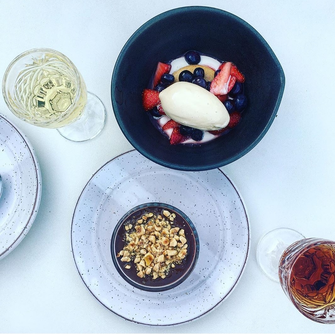 Goat Cheese Mousse, Pate Sucree, Macerated Berries, Burnt Honey Ice Cream. And Dark Chocolate Coffee Pot de Creme, Hazelnut, Olive Oil, Smoked Salt. Both on this weeks menu. We still have a handful of reservations available this week. Book through Resy or calling the restaurant.