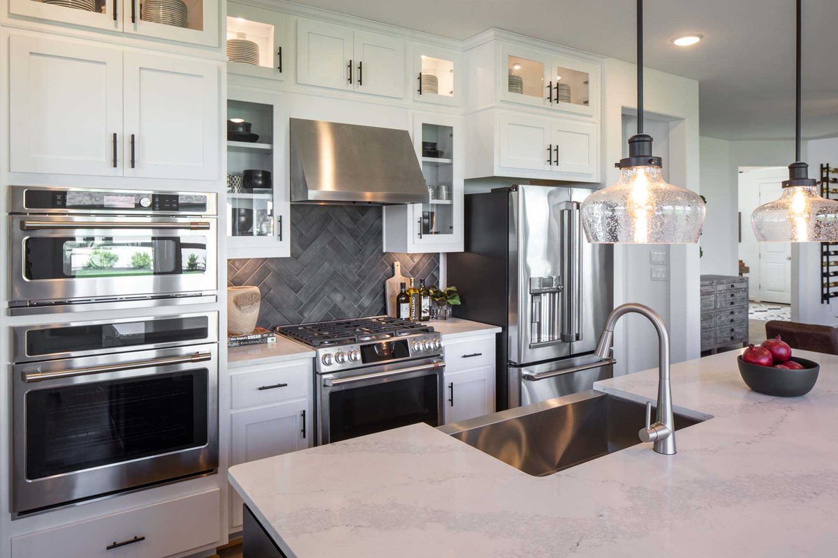 Elevate your kitchen design with a chic and modern pattern like this herringbone tile backsplash. #HighlandHomesTX View More: bit.ly/2VhpJos