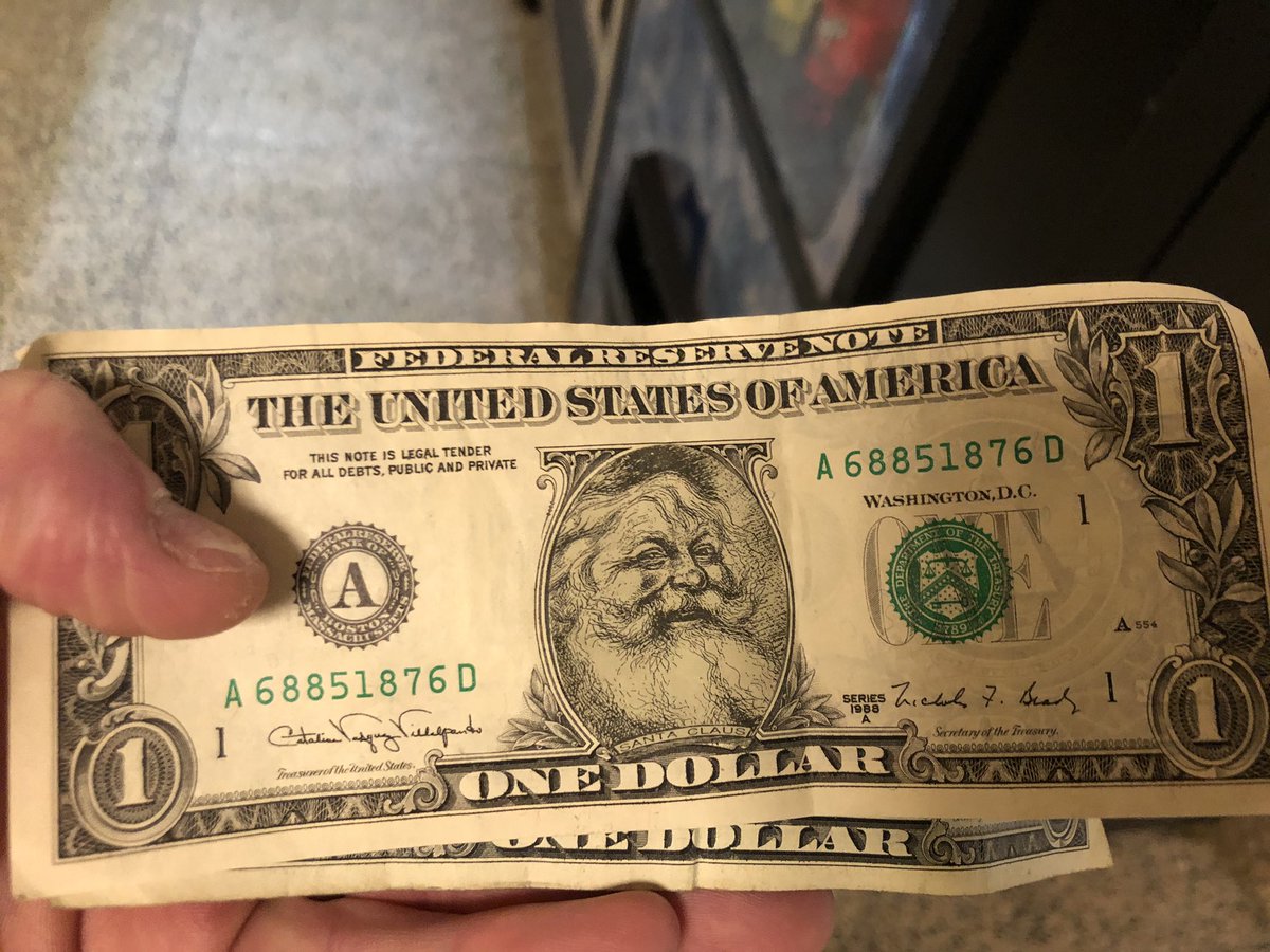 Check out the dollar bill that kept getting rejected by the vending machine until I looked more closely at its front - well played, Santa, well played...
