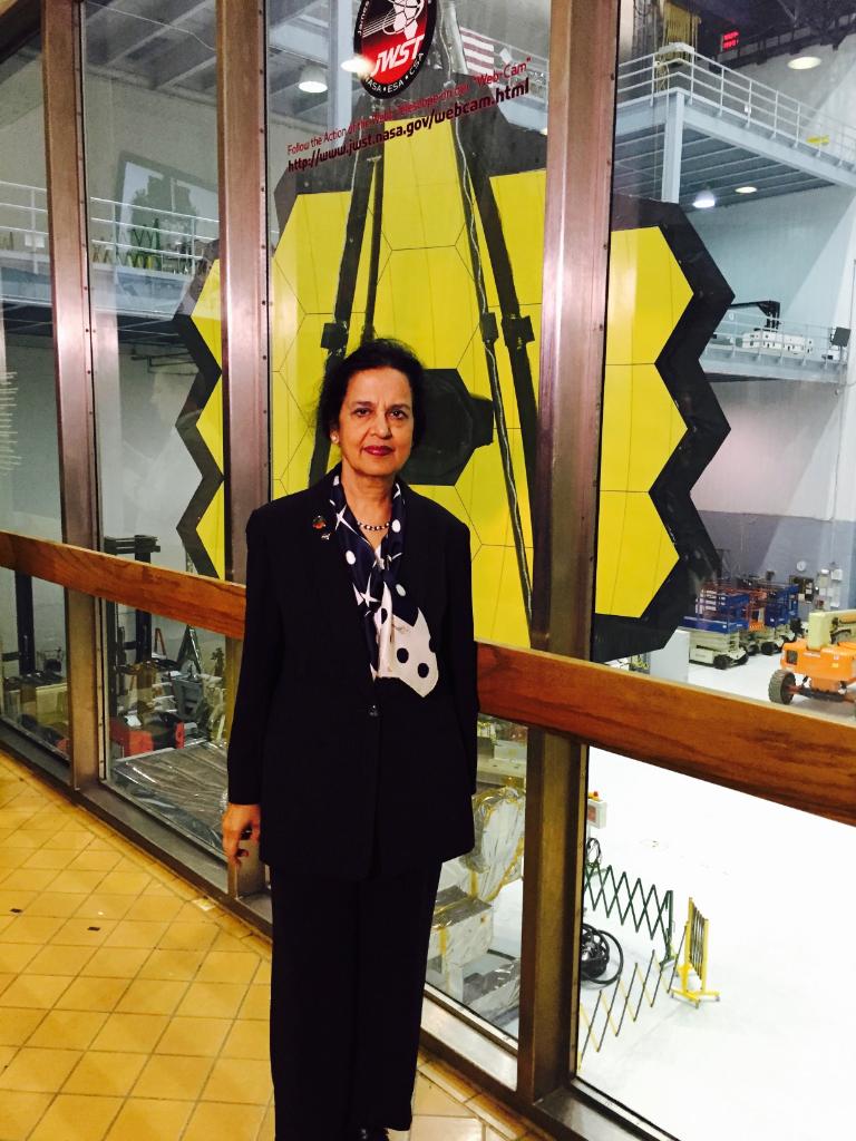 Hashima Hasan in front of the James Webb Space Telescope.