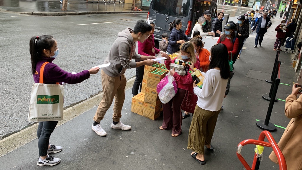 Thaitown, Sydney, 1pm. They’ve started handing out today’s food and essentials to students etc. The last item is an envelope with some cash. The people you see lined up here are maybe a quarter of the queue, which stretches back around the block.
