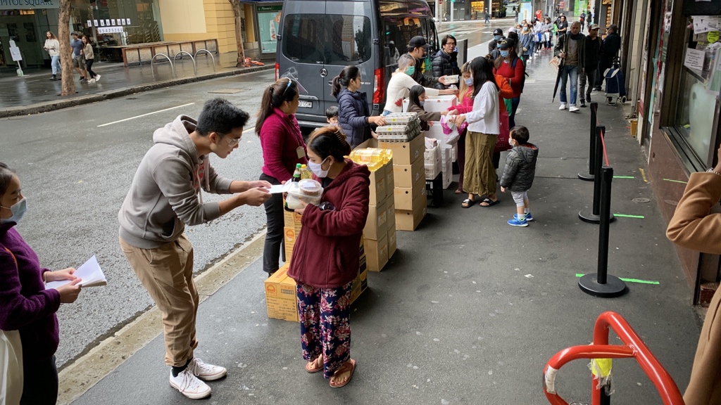 Thaitown, Sydney, 1pm. They’ve started handing out today’s food and essentials to students etc. The last item is an envelope with some cash. The people you see lined up here are maybe a quarter of the queue, which stretches back around the block.