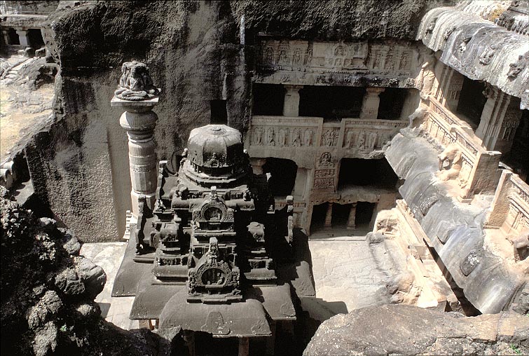 The courtyard of  #Jain Cave 32 , Ellora, 9th century.A southern style rock carved shrine and a monolithic stambha standin the courtyard surrounded by cave temples on three sides.