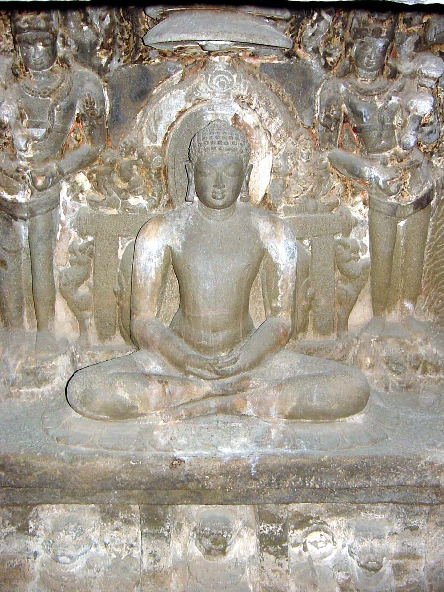  #Jain Tirthankar Mahavira surrounded by two guards in the upper sanctuary of cave 32 of Jain worship in Ellora.The ceiling of the sanctuary with carved pillars is decorated with a lotus.