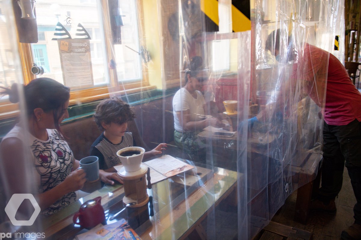 Cafe owner Francini Osorio serves customers in a trial phase during the coronavirus lockdown. He has installed an air purifier and 35 clear shower curtains, which will divide customers and tables.

📷Jacob King/PA Images - contact us at paimages.co.uk/contact

#coronavirusuk