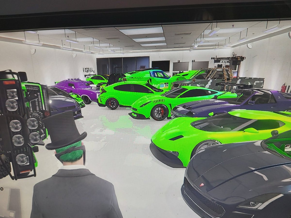 ryan_huddart's tweet photo. @RockstarGames 
When I loaded in this was my garage.  I don't own any of the neon green vehicles. This is on my xbox account. https://t.co/GJKKvFUJVa