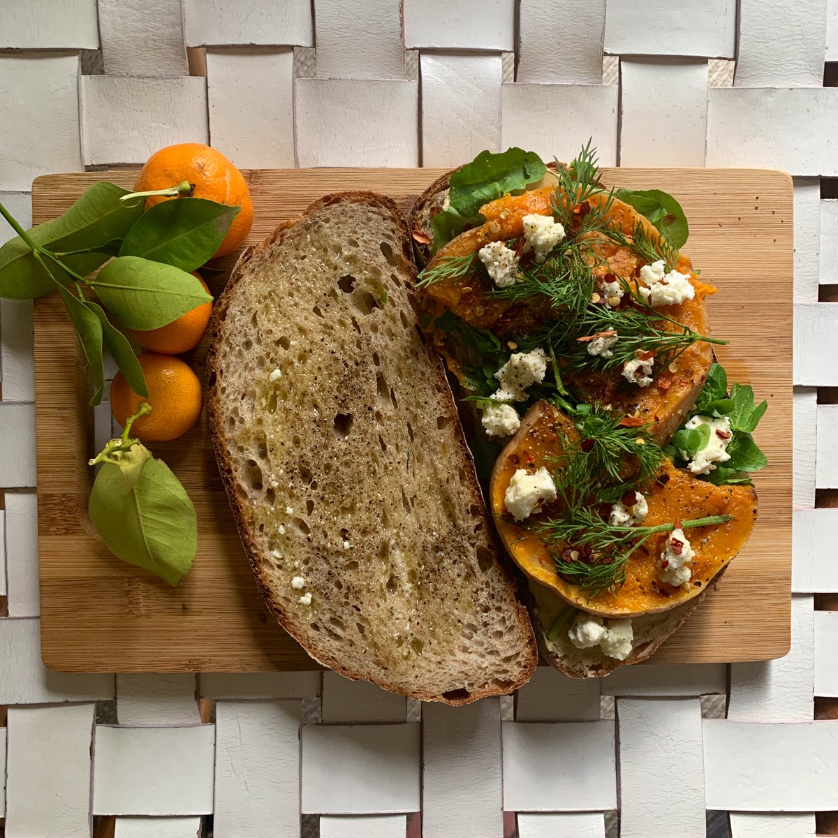 this is a sanga! hummus, leftover roast pumpkin, cashew cheese, dill n watercress on rye. also kumquats