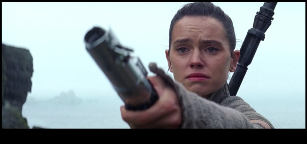 At the very end of the movie Rey finds Luke, and immediately attempts to hand the saber over to him. In her mind the saber is still very much Lukes. She thinks of Luke as still the legendary hero, i.e. the main character.