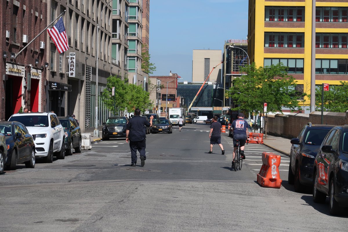 12stTales's tweet image. A @FDNY firefighter at #Engine34 rolls around on a bike while another hollers at his colleagues to move their parked cars for the bike lane going in on the N side of the Street.