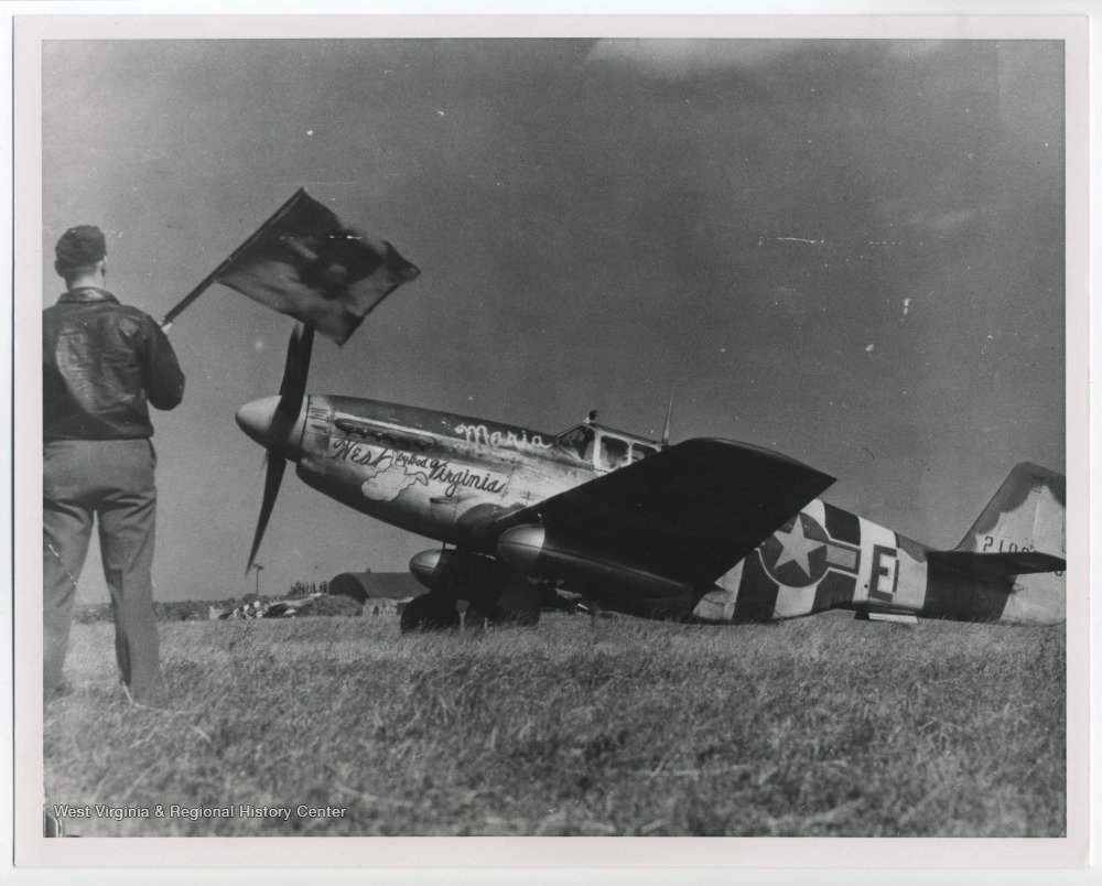 This photo of a P-51 Mustang Fighter plane was taken before the allied invasion of Normandy on June 6, 1944. The aircraft pictured was piloted by Captain Dayton Casto, a graduate from WVU’s Law School. He served with the 375th Squadron of the 361st Fighter Group, 8th Air Force.