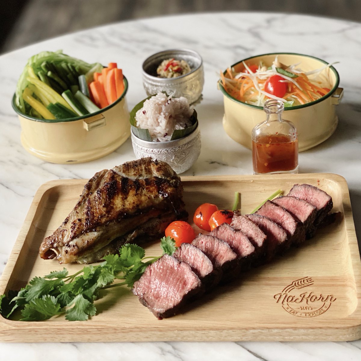 NaKorn Memorial Day Thai Picnic, you get:
• Grilled marinated bone-in chicken breast
• Grilled Grass-Fed Strip Loin
• Green Papaya Salad
• Thai Anchovy Relish
Pre-order by tomorrow for pick up or delivery on Monday May 25 @ nakornkitchen.com.