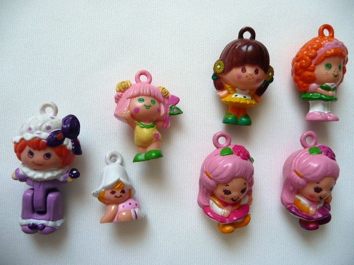 See those little loops on their heads? You could wear them on a bracelet or necklace, like a charm. Yes, truly these adorable little people are akin to charms. They are, you might say, The Charmkins.Remember the Charmkins? They're neither back, nor in pog form.