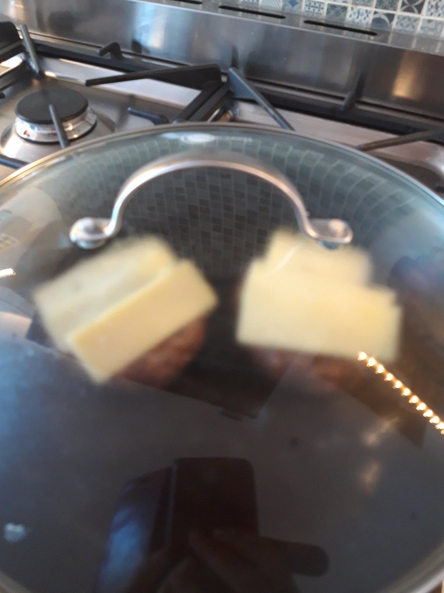 Step 8: cheese. Slice some cheddar, whack it on the cooked burgers and put the lid on. Leave for a few minutes to melt (upturned bowl also fine if your pan doesn't have a lid)