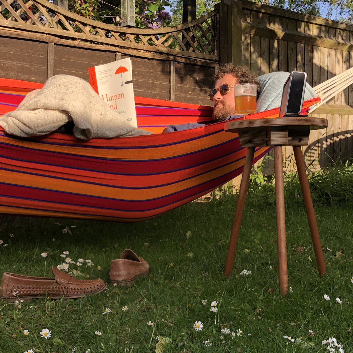 michaelbuick's tweet photo. Housemate Rob chomping through  #humankind book by @rcbregman aided by a beer, hammock and my @peggfurniture table :-) ... I’m next in the queue to read... #AskRutger https://t.co/9ekYyu8SSy
