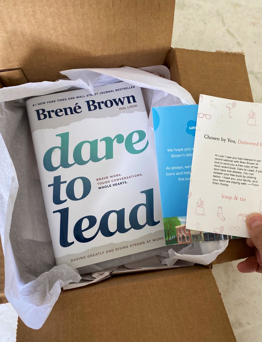 Open box containing a hardcover copy of “Dare to Lead” by Brené Brown, and two thank you cards from Salesforce.