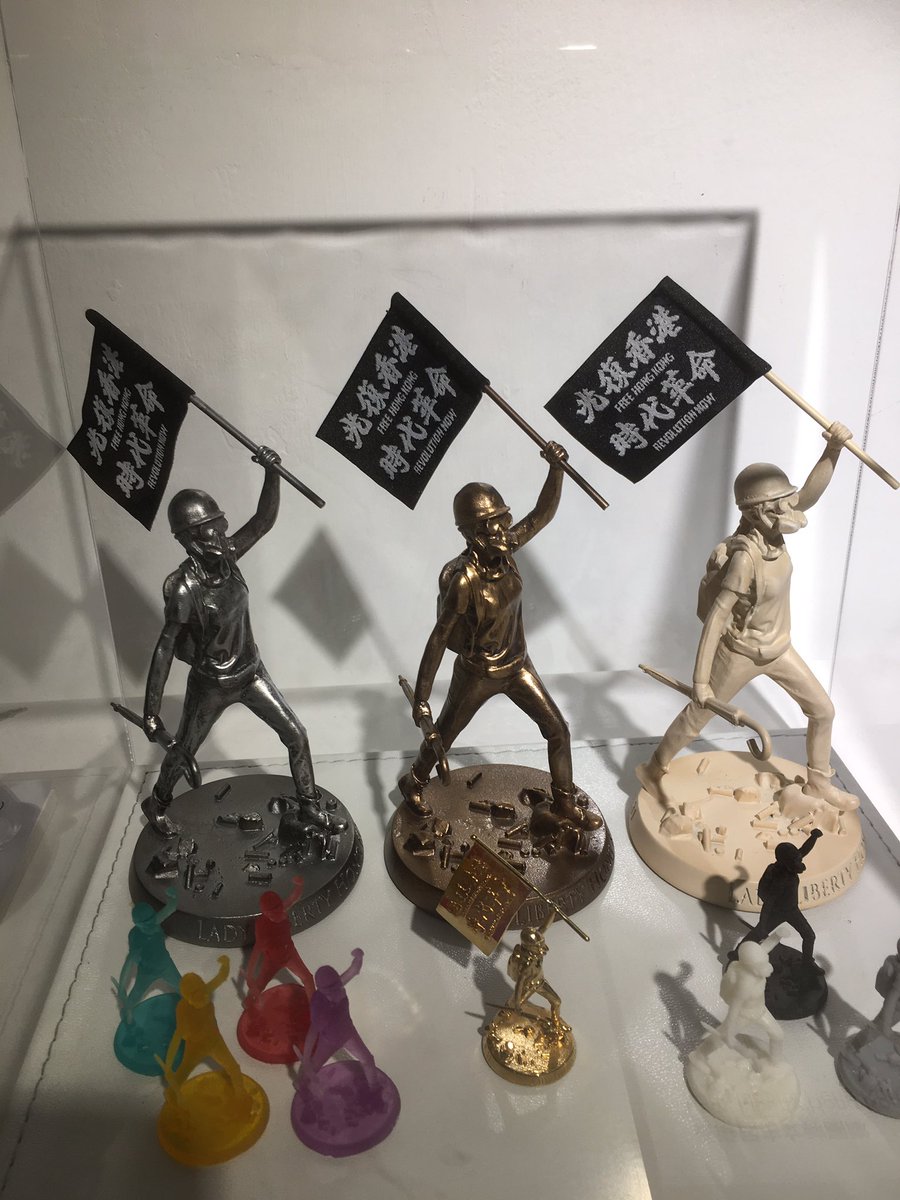 A portion of the exhibit shows how  #LadyLiberty was made, prototypes manufactured with a 3D printer that plays  #GloryToHongKong over and over again.