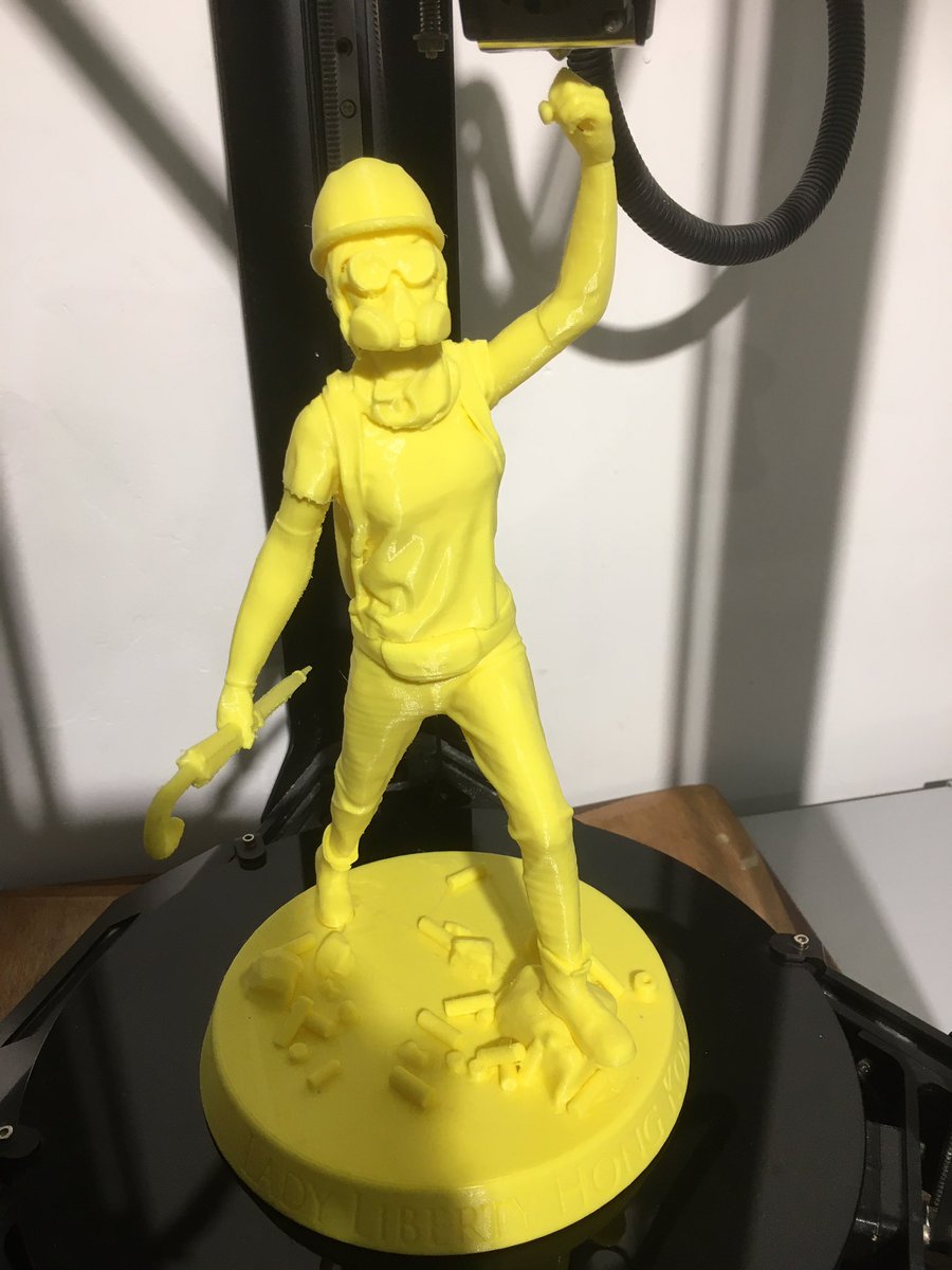 A portion of the exhibit shows how  #LadyLiberty was made, prototypes manufactured with a 3D printer that plays  #GloryToHongKong over and over again.